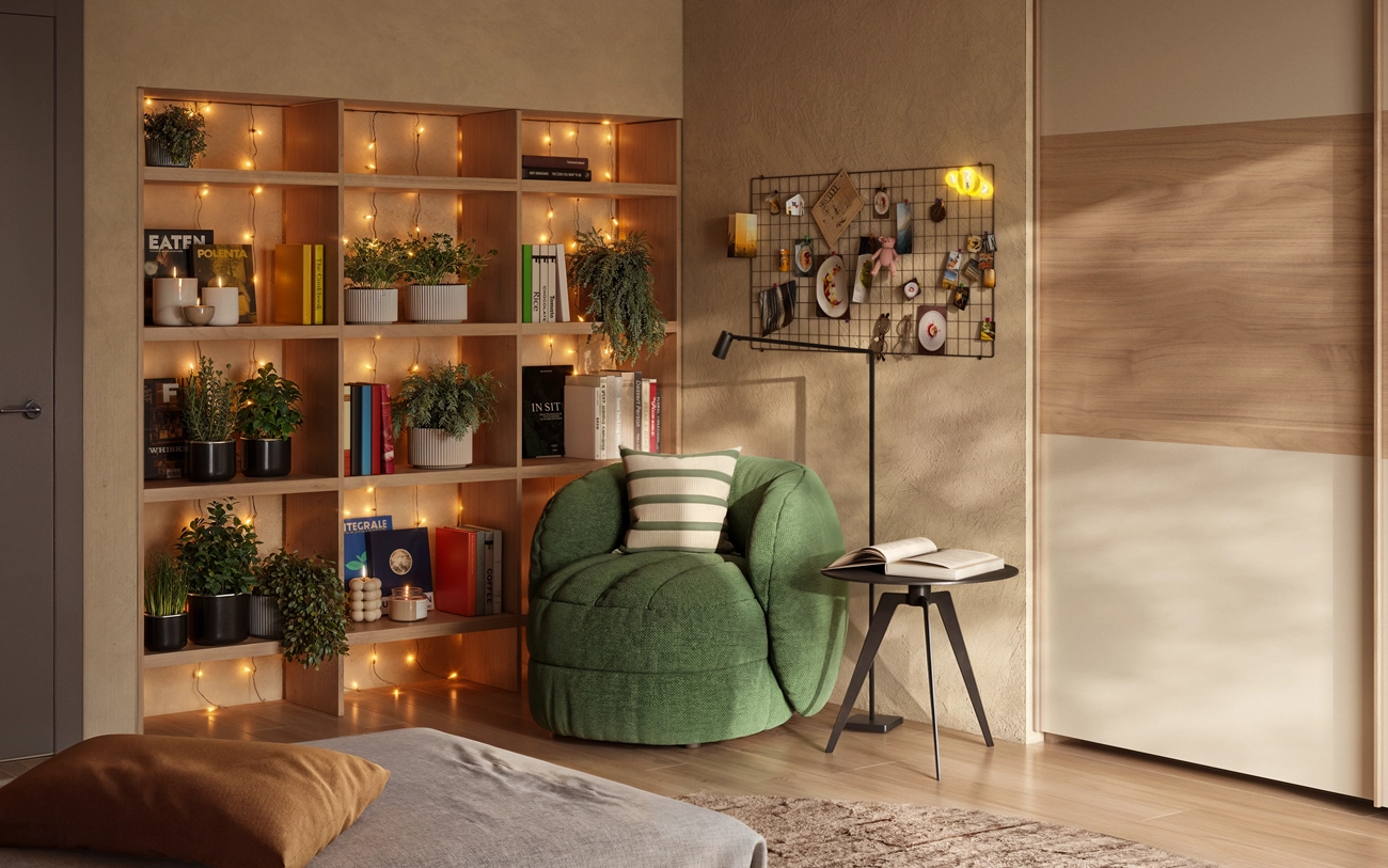 Angolo lettura con libreria e poltrona verde